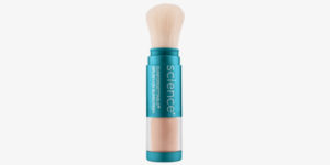 A teal and copper makeup brush with dense, soft bristles labeled "science" in a bold, white font, indicating a branding theme centered around scientific innovation in beauty.