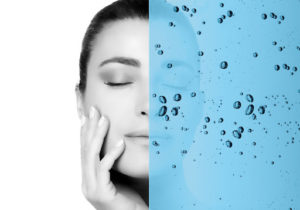 Model's hydrated face on half of screen with water on other half for Lincoln Spa & Aesthetics
